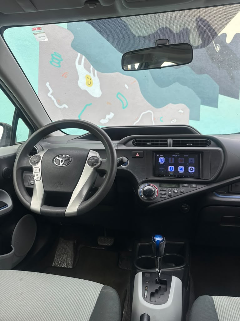 Toyota Prius C side view economical hybrid car Santa Cruz Capitola city transport